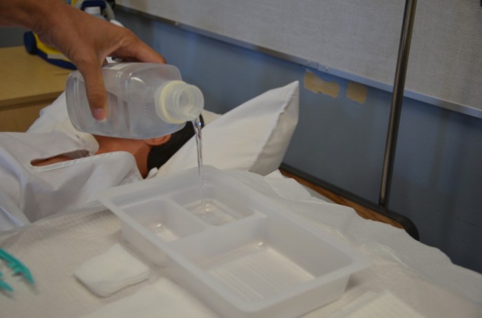 A nurse is preparing a sterile field